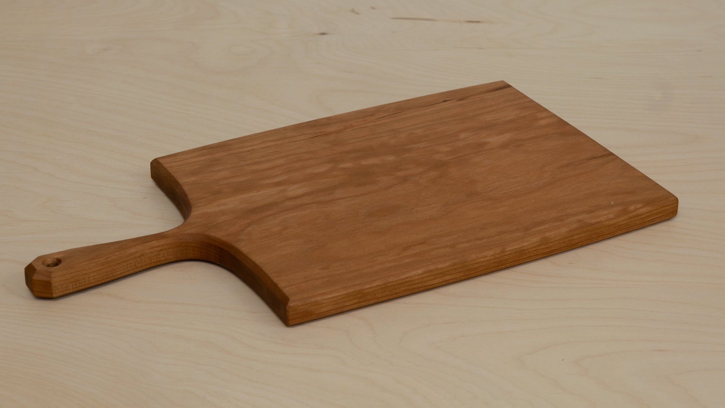 Wooden cutting board on a light wooden surface